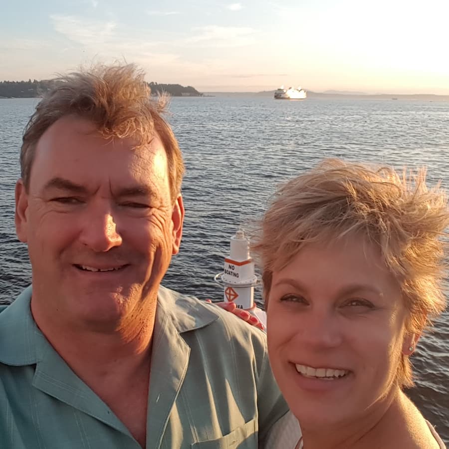Innkeepers Chris and Sarah standing near water with buoy in floating in the water