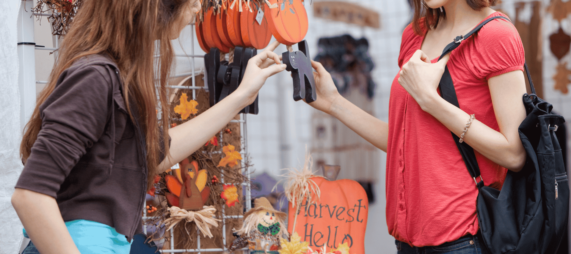Women shopping at a craft fair with fall decor